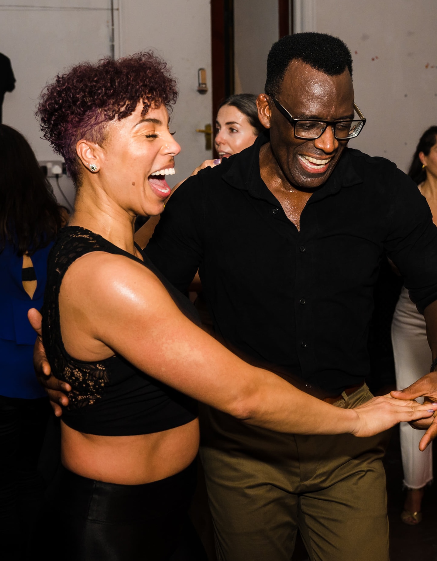 A smiling couple dancing at a Funky Mambo social