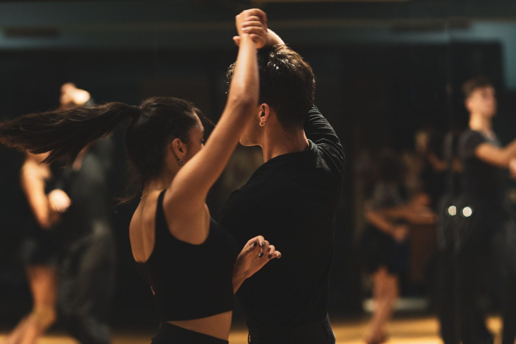 A Salsa couple practising a turn together in class